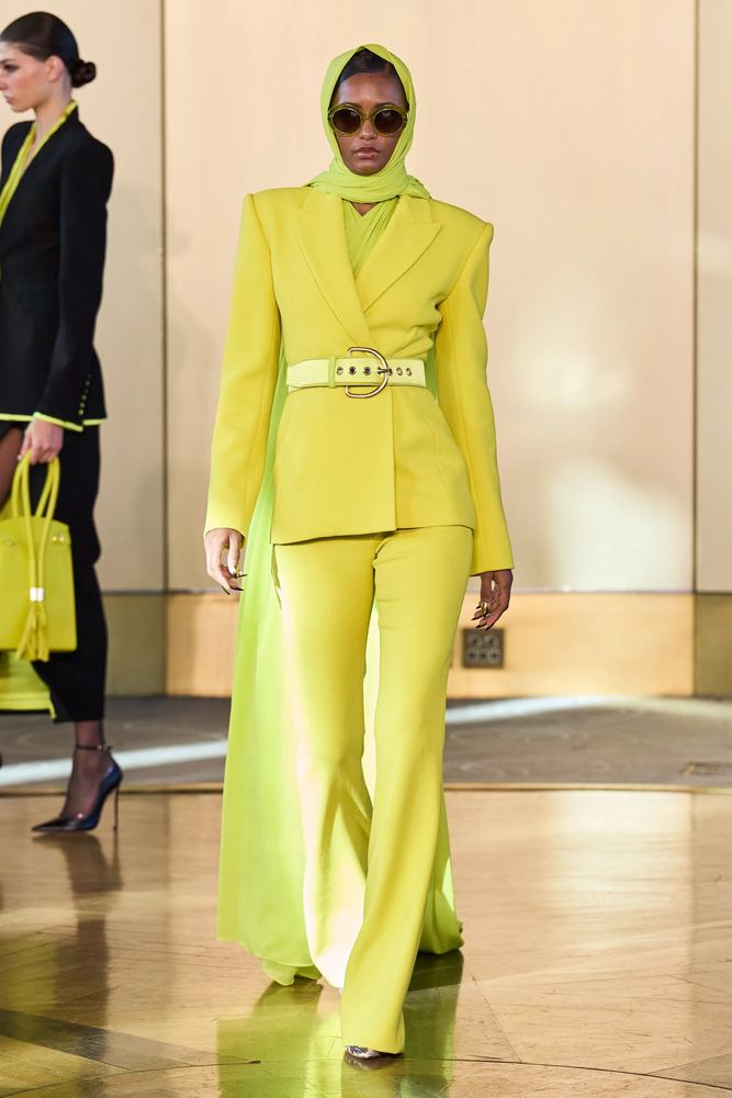 Acid lime suit with a belted jacket, flared trousers and a matching head scarf, Sergio Hudson S/S 27, New York.