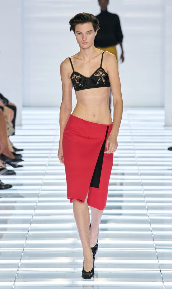 Red wrap pencil skirt with a black lace bralette, Prada S/S 27, Milan.