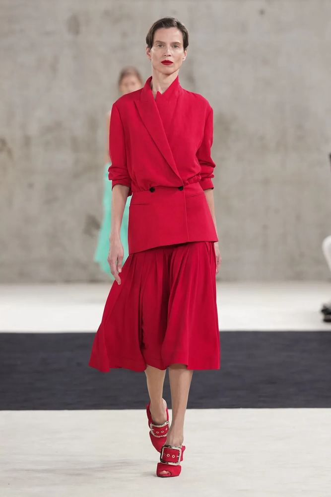 Scarlet double-breasted jacket over a pleated midi skirt, Lanvin S/S 27, Paris.