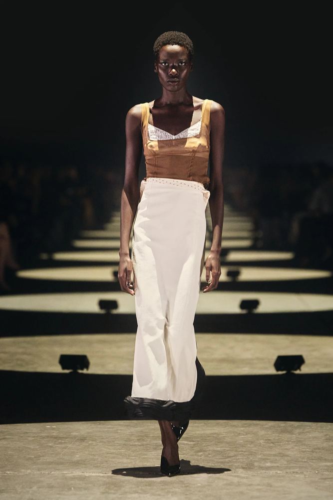 Caramel bustier corset top with a lace edge over a long ivory skirt, Khaite S/S 27, New York.