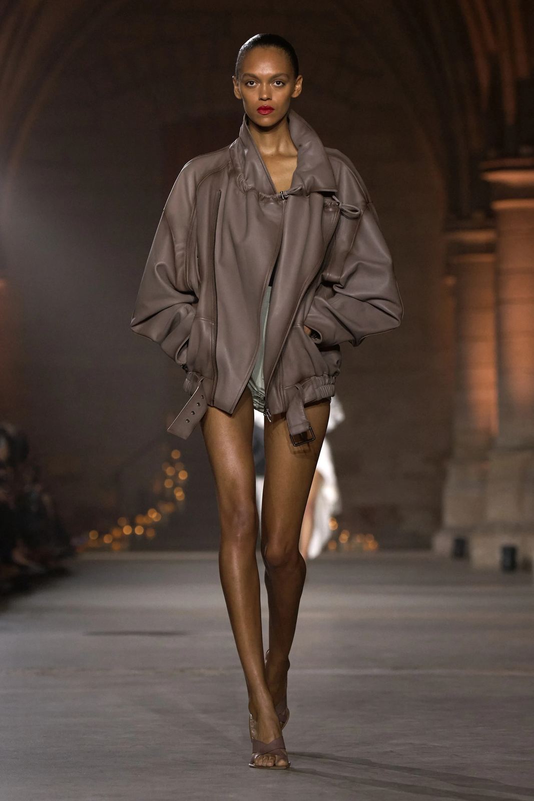 Oversized taupe leather biker jacket worn as the whole look, Victoria Beckham S/S 27, Paris.