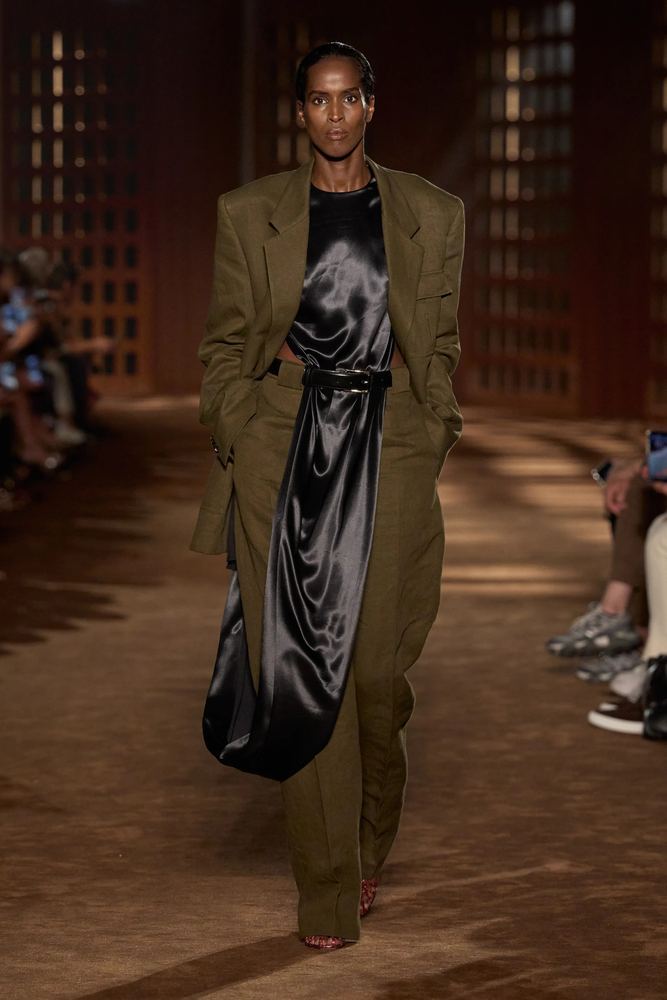Oversized olive blazer and wide trousers over a liquid black satin slip, Ferragamo S/S 27, Milan.