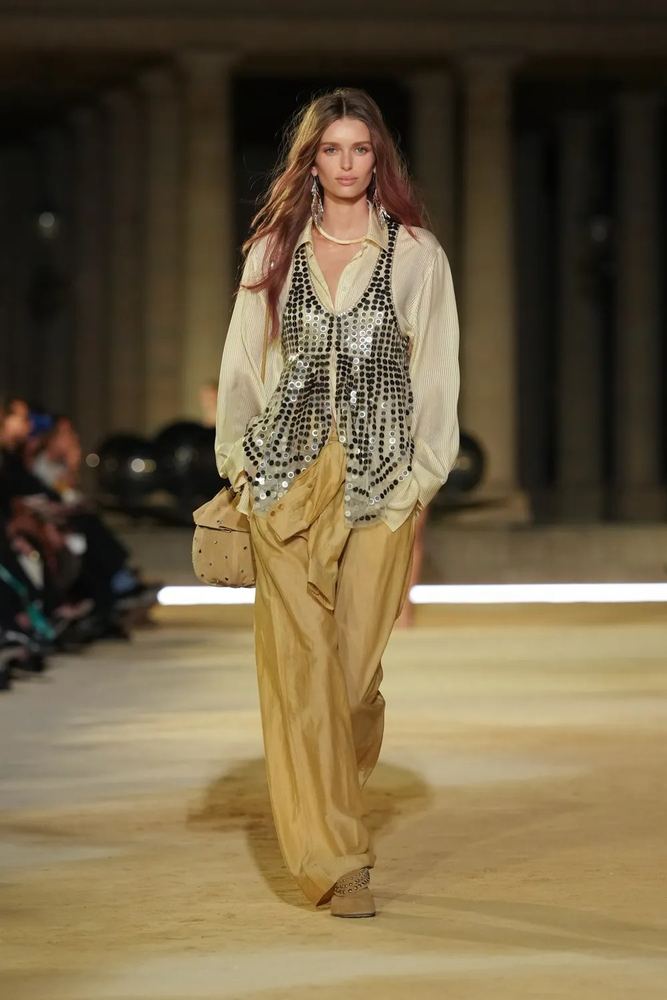 Fluid sand wide leg trousers under a paillette waistcoat and silk shirt, Isabel Marant S/S 27, Paris.