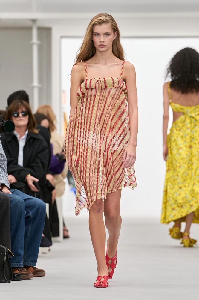 Sheer red and sand candy stripes on a loose slip dress with a handkerchief hem, Loewe S/S 27, Paris.