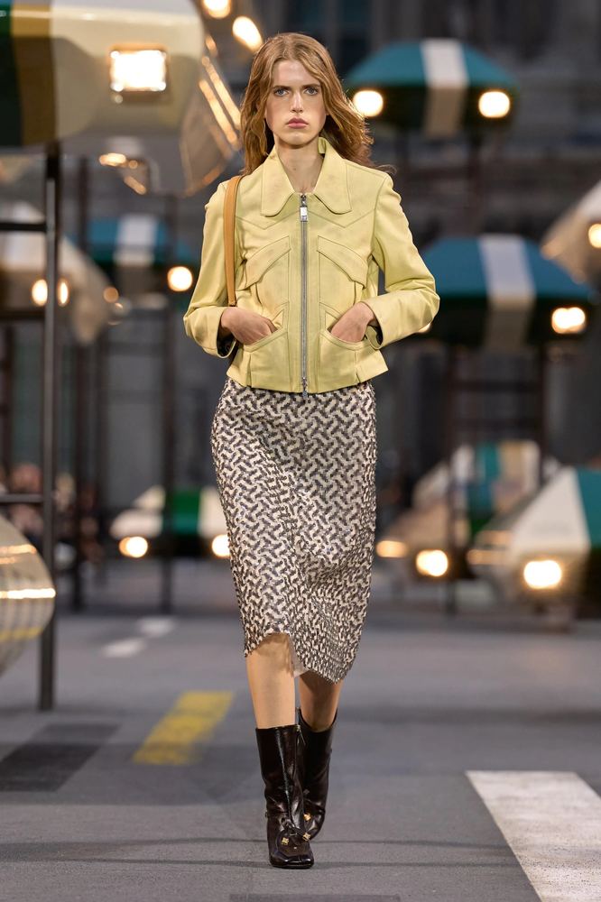 Micro-geometric foulard print on a straight midi skirt with a butter-yellow leather jacket, Louis Vuitton S/S 27, Paris.