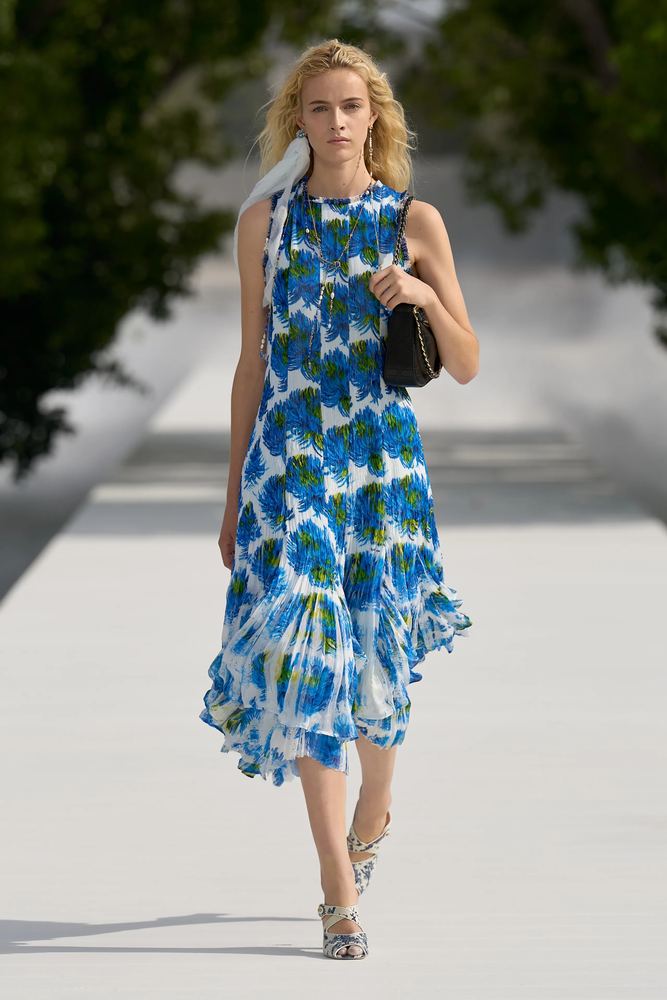 Blue hydrangea print on a pleated sleeveless dress with an asymmetric hem, Christian Dior S/S 27, Paris.