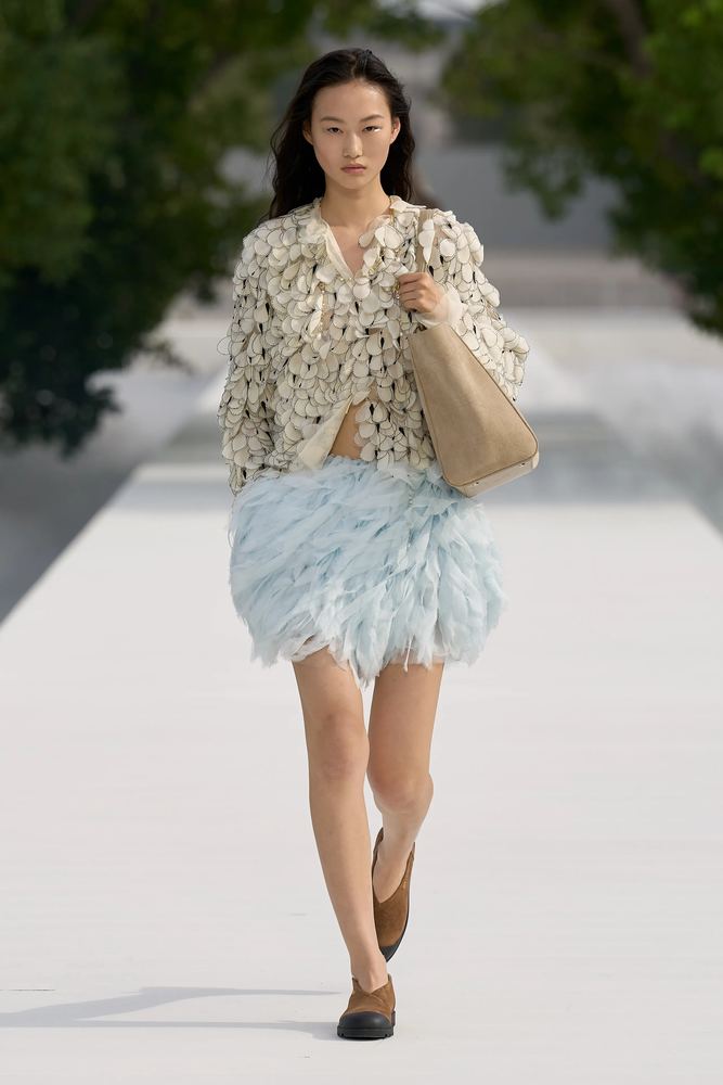 Petal-textured knit cardigan over a feathered pale blue miniskirt, Christian Dior S/S 27, Paris.